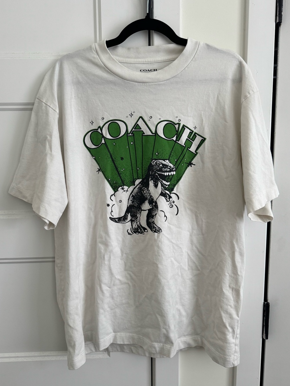 Coach Boutique Rexy Dinosaur Men’s Short Sleeve Relaxed Fit Tee in Vintage White